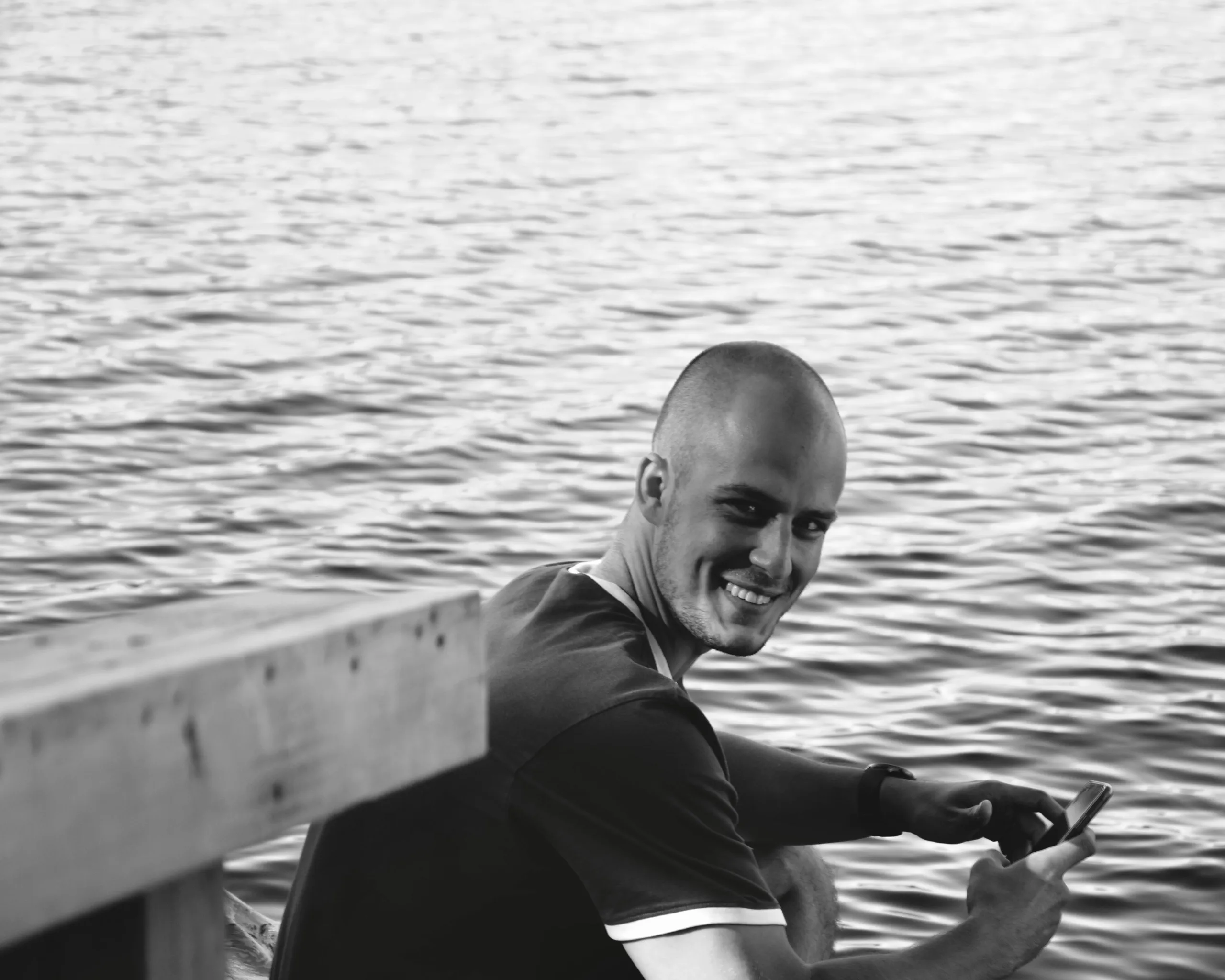 Portrait d’un homme accoudé face à la mer, en noir et blanc